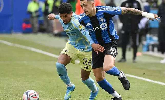CF Montreal's Ivan Jaime (10) tries to get by Philadelphia Union's Nathan Harriel (26) during the first half of an MLS soccer match in Montreal, Saturday, April 11, 2026. (Graham Hughes/The Canadian Press via AP)