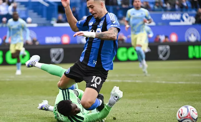 Philadelphia Union goalkeeper Andre Blake stops CF Montreal's Ivan Jaime (10) during the first half of an MLS soccer game in Montreal, Saturday, April 11, 2026. (Graham Hughes/The Canadian Press via AP)