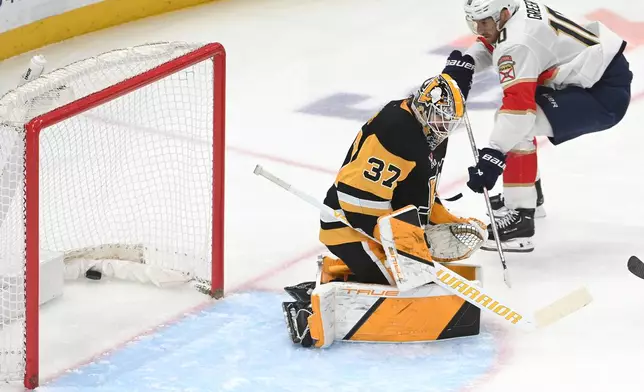 Florida Panthers left wing A.J. Greer (10) scores on Pittsburgh Penguins goalie Arturs Silovs (37) during the first period of an NHL game, Saturday, April 4, 2026, in Pittsburgh. (AP Photo/Philip G. Pavely)