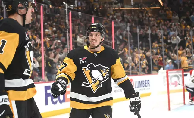 Pittsburgh Penguins center Evgenii Malkin (71) is congratulated by right wing Rickard Rakell (67) after scoring his second goal of the game against the Florida Panthers during the second period of an NHL game, Saturday, April 4, 2026, in Pittsburgh. (AP Photo/Philip G. Pavely)