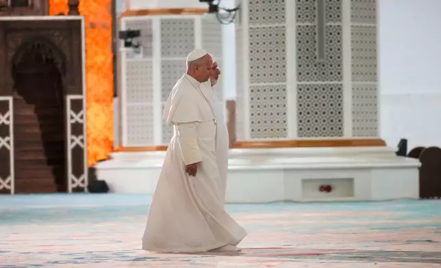 Pope Leo XIV is welcomed by Rector Mohamed Mamoun Al Qasimi upon his arrival at the Great Mosque in Algiers, Monday, April 13, 2026, on the first day of an 11-day apostolic journey to Africa. (AP Photo/Andrew Medichini)
