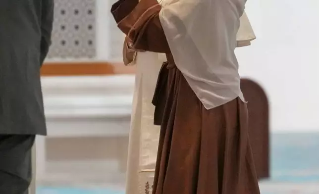 Pope Leo XIV listens to explanations upon his arrival at the Great Mosque in Algiers, Monday, April 13, 2026, on the first day of an 11-day apostolic journey to Africa. (AP Photo/Andrew Medichini)