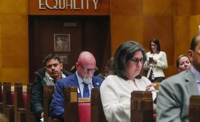 Members of the public listen during a City Council meeting considering whether to repeal a newly approved proposal limiting cooperation with U.S. Immigration and Customs Enforcement at City Hall, in Houston, Wednesday, April 22, 2026. (Raquel Natalicchio/Houston Chronicle via AP)