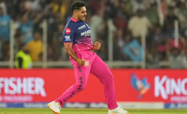 Rajasthan Royals Tushar Deshpande celebrates the wicket of Gujarat Titans' Rashid Khan during the Indian Premier League cricket match between Gujarat Titans and Rajasthan Royals in Ahmedabad, India, Saturday, April 4, 2026. (AP Photo/Ajit Solanki)