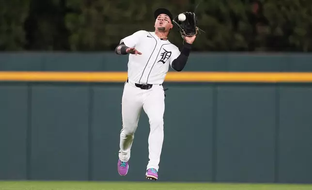 Detroit Tigers center fielder Javier Báez (28) catches a Kansas City Royals' Starling Marte fly ball during the ninth inning of a baseball game Tuesday, April 14, 2026, in Detroit. (AP Photo/Paul Sancya)