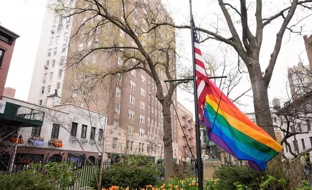 A rainbow Pride flag flies with an American flag at the Stonewall National Monument in New York, Monday, April 13, 2026. (AP Photo/Seth Wenig)