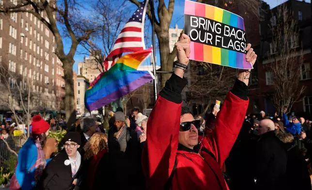 FILE - People demonstrate after New York politicians and activists raised a rainbow flag on a pole across the street from the Stonewall Inn, Thursday, Feb. 12, 2026, in New York, a few days after it was removed by the National Park Service to comply with guidance from the Trump administration. (AP Photo/Yuki Iwamura, File)
