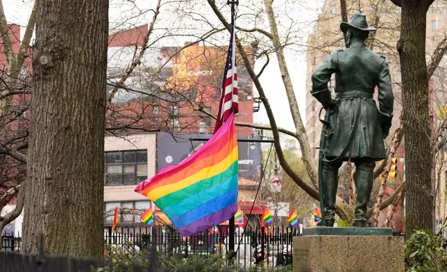 A rainbow Pride flag flies with an American flag at the Stonewall National Monument in New York, Monday, April 13, 2026. (AP Photo/Seth Wenig)