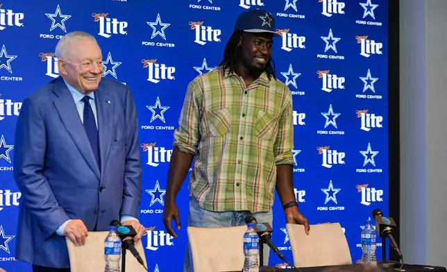 Dallas Cowboys first-round draft pick Malachi Lawrence, right, and team owner Jerry Jones, left, arrive for an NFL football news conference at the team's headquarters Friday, April 24, 2026, in Frisco, Texas. (AP Photo/Tony Gutierrez)