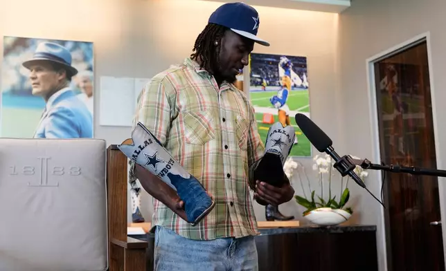 Dallas Cowboys first round draft pick Malachi Lawrence responds to a question after being fitted for a custom pair of boots at the NFL football team's headquarters Friday, April 24, 2026, in Frisco, Texas. (AP Photo/Tony Gutierrez)