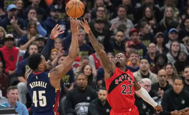Cleveland Cavaliers guard Donovan Mitchell (45) shoots over Toronto Raptors guard Jamal Shead (23) in the first half in Game 2 of a first-round NBA basketball playoffs series in Cleveland, Monday, April 20, 2026. (AP Photo/Sue Ogrocki)