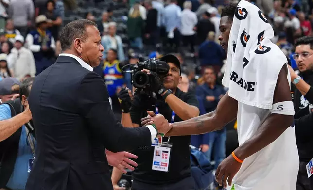 Minnesota Timberwolves guard Anthony Edwards (5) shakes hands with owner Alex Rodriguez after defending the Denver Nuggets in Game 2 of a first-round NBA playoffs basketball series Monday, April 20, 2026, in Denver. (AP Photo/Jack Dempsey)