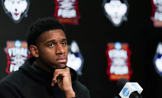 UConn forward Tarris Reed Jr. listens during a news conference ahead of a national championship NCAA college basketball tournament game against Michigan at the Final Four, Sunday, April 5, 2026, in Indianapolis. (AP Photo/Jeff Roberson)