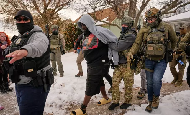 FILE - Garrison Gibson is arrested by federal immigration officers Jan. 11, 2026, in Minneapolis. (AP Photo/John Locher, File)