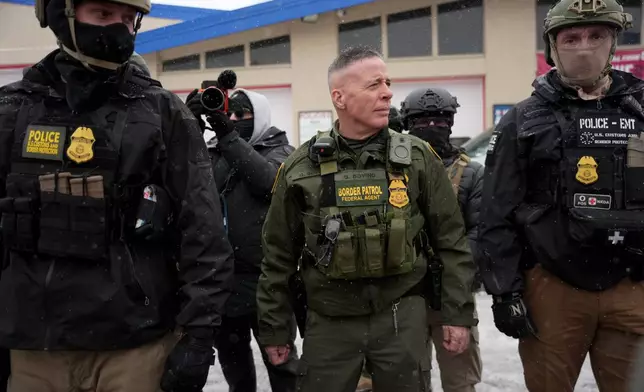 FILE - U.S. Border Patrol Cmdr. Gregory Bovino walks with Federal agents outside a convenience store Jan. 21, 2026, in Minneapolis. (AP Photo/Angelina Katsanis, File)