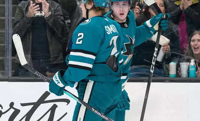 San Jose Sharks left wing Igor Chernyshov, right, celebrates with teammate Will Smith (2) after scoring a goal during the first period of an NHL hockey game against the Vancouver Canucks in San Jose, Calif., Saturday, April 11, 2026. (AP Photo/Tony Avelar)