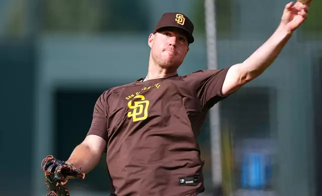 San Diego Padres first baseman Gavin Sheets warms up before a baseball game against the Colorado Rockies Tuesday, April 21, 2026, in Denver. (AP Photo/David Zalubowski)
