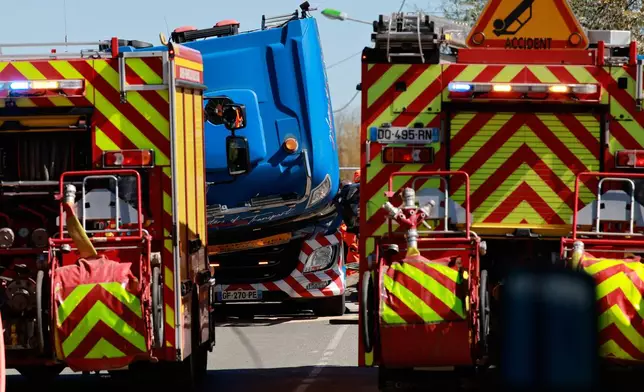 A truck carrying military equipment is pictured after crashing against a high-speed train (TGV) in Bully-les-Mines, northern France, Tuesday, April 7, 2026. (AP Photo/Jean-Francois Badias)