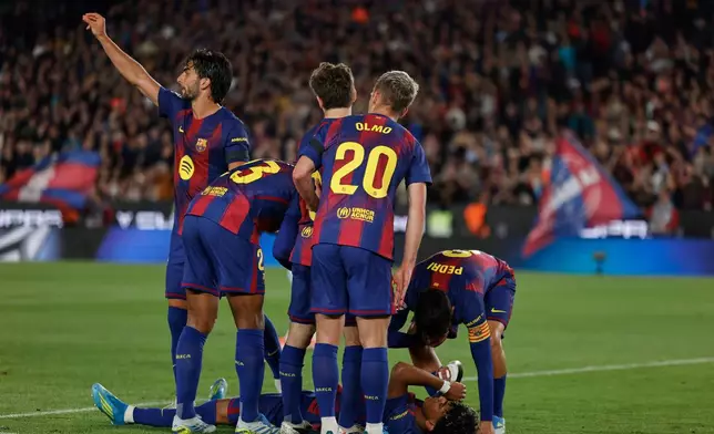 Barcelona's Lamine Yamal lies on the pitch in pain during the Spanish La Liga soccer match between Barcelona and Celta Vigo in Barcelona, Spain, Wednesday, April 22, 2026. (AP Photo/Joan Monfort)