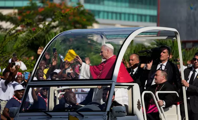 Pope Leo XIV waves after arriving in Luanda, Angola, Saturday, April 18, 2026 on the sixth day of his 11-day pastoral visit to Africa. (AP Photo/Themba Hadebe)