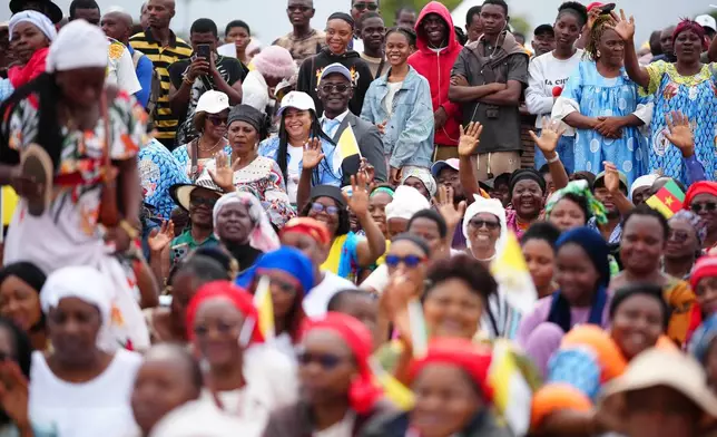 People wait for Pope Leo XIV at Yaounde Ville Airport, Cameroon, Saturday, April 18, 2026 on the sixth day of his 11-day pastoral visit to Africa. (AP Photo/Andrew Medichini)