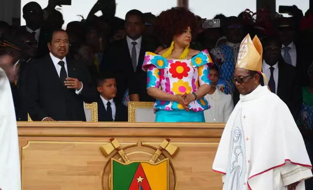 Cameroon's President Paul Biya, left, and his wife Chantal wait for the start of a Mass celebrated by Pope Leo XIV at Yaounde Ville Airport, Cameroon, Saturday, April 18, 2026 on the sixth day of his 11-day pastoral visit to Africa. (AP Photo/Andrew Medichini)