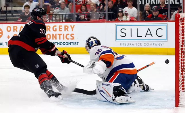 Carolina Hurricanes' Andrei Svechnikov (37) shoots the puck wide of New York Islanders goaltender Ilya Sorokin (30) during the second period of an NHL hockey game in Raleigh, N.C., Saturday, April 4, 2026. (AP Photo/Karl DeBlaker)