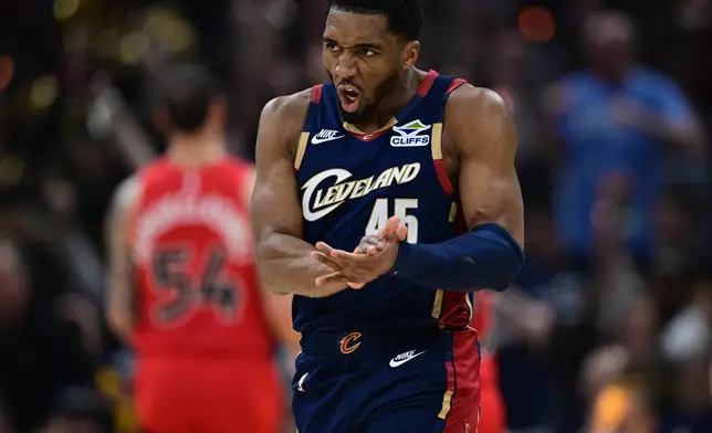 Cleveland Cavaliers guard Donovan Mitchell reacts after an assist during the first half in Game 1 of a first-round NBA playoffs basketball series against the Toronto Raptors, Saturday, April 18, 2026, In Cleveland. (AP Photo/David Dermer)