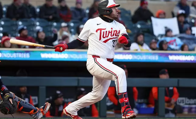 Minnesota Twins catcher Victor Caratini hits an RBI sacrifice fly against the Detroit Tigers during the third inning of baseball game Monday, April 6, 2026, in Minneapolis. (AP Photo/Matt Krohn)