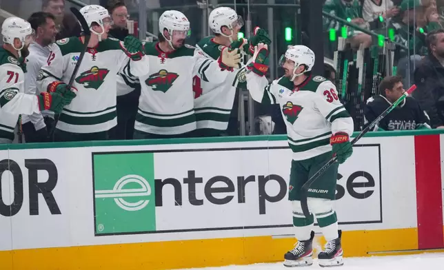 Minnesota Wild right wing Mats Zuccarello skates by his bench after scoring a goal against the Dallas Stars during the first period in Game 5 of a first-round NHL Stanley Cup playoffs hockey series, Tuesday, April 28, 2026, in Dallas. (AP Photo/Julio Cortez)