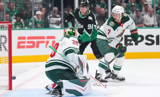A shot by Dallas Stars defenseman Miro Heiskanen, not visible, gets by Minnesota Wild goaltender Jesper Wallstedt (30) for a goal during the first period in Game 5 of a first-round NHL Stanley Cup playoffs hockey series, Tuesday, April 28, 2026, in Dallas. (AP Photo/Julio Cortez)