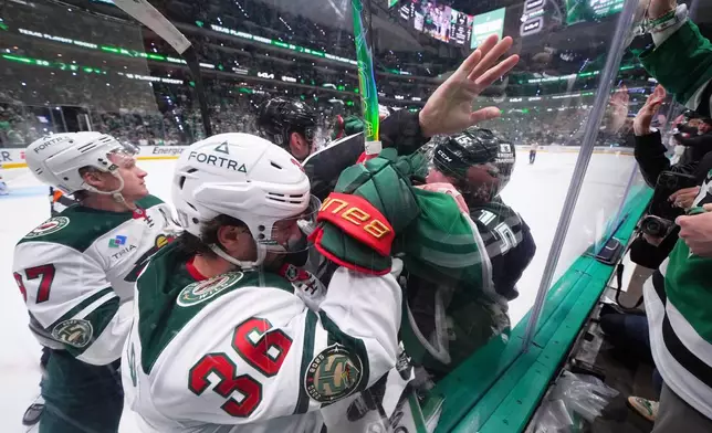 Minnesota Wild right wing Mats Zuccarello (36) and Dallas Stars center Colin Blackwell, right, scuffle at the end of the first period in Game 5 of a first-round NHL Stanley Cup playoffs hockey series, Tuesday, April 28, 2026, in Dallas. (AP Photo/Julio Cortez)