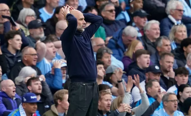 Manchester City's head coach Pep Guardiola gestures during the English Premier League soccer match between Manchester City and and Arsenal, in Manchester, England, Sunday, April 19, 2026. (AP Photo/Dave Thompson)
