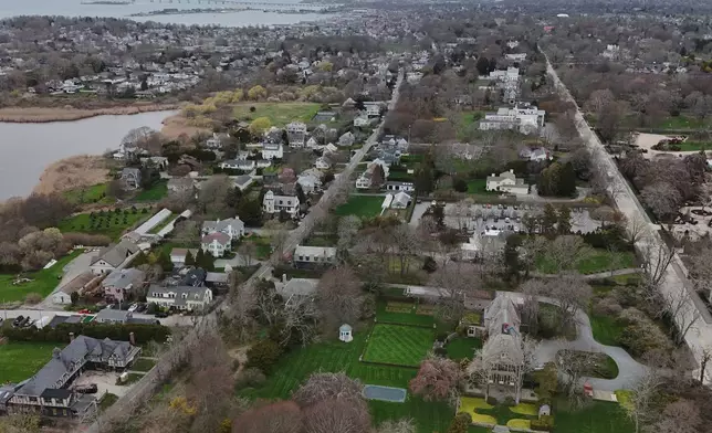 Trees surround homes Wednesday, April 22, 2026, in Newport, R.I. (AP Photo/Joshua A. Bickel)