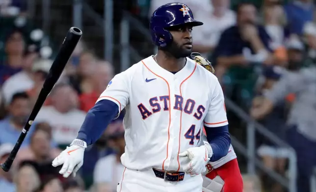 Houston Astros designated hitter Yordan Alvarez tosses his bat after being hit by a pitch as he stares down Boston Red Sox starting pitcher Garrett Crochet during the fifth inning of a baseball game Wednesday, April 1, 2026, in Houston. (AP Photo/Michael Wyke)