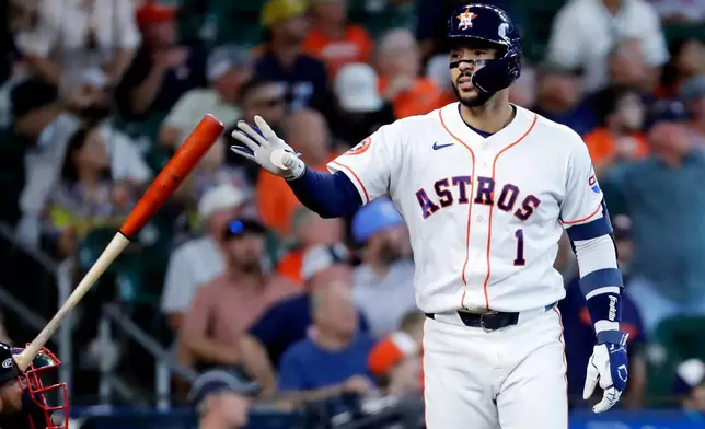 Houston Astros' Carlos Correa flips his bat before rounding the bases on this three-run home run against the Boston Red Sox during the fifth inning of a baseball game Wednesday, April 1, 2026, in Houston. (AP Photo/Michael Wyke)