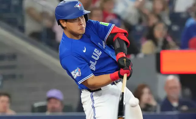 Toronto Blue Jays' Kazuma Okamoto (7) singles off Cleveland Guardians pitcher Matt Festa (52) during the sixth inning of a baseball game in Toronto, Saturday, April 25, 2026. (Chris Young/The Canadian Press via AP)