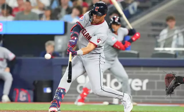 Cleveland Guardians' Juan Brito hits a double off Toronto Blue Jays pitcher Kevin Gausman during the third inning during the third inning of a baseball game in Toronto, Saturday, April 25, 2026. (Chris Young/The Canadian Press via AP)