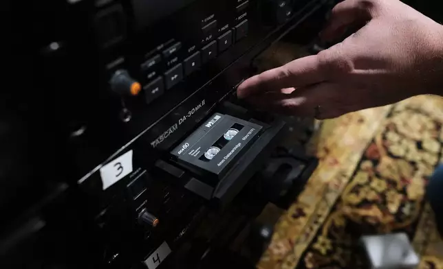 Brian Emerick plays a recorded tape at his home in Des Plaines, Ill., Thursday, March 19, 2026. (AP Photo/Nam Y. Huh)