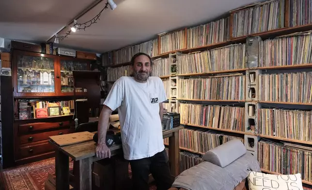 Aadam Jacobs poses in front of LP (long play) record storage bookcase at his home in Chicago, Thursday, March 19, 2026. (AP Photo/Nam Y. Huh)