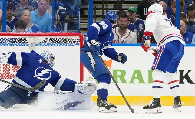 Montréal Canadiens center Kirby Dach (77) watches his shot get past Tampa Bay Lightning goaltender Andrei Vasilevskiy (88) and center Gage Goncalves (93) for a goal during the second period in Game 5 of an NHL hockey Stanley Cup first-round playoff series, Wednesday, April 29, 2026, in Tampa, Fla. (AP Photo/Chris O'Meara)