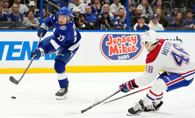 Tampa Bay Lightning center Dominic James (17) shoots for a goal after getting past Montréal Canadiens defenseman Lane Hutson (48) during the second period in Game 5 of an NHL hockey Stanley Cup first-round playoff series, Wednesday, April 29, 2026, in Tampa, Fla. (AP Photo/Chris O'Meara)