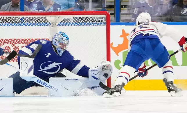 Tampa Bay Lightning goaltender Andrei Vasilevskiy (88) makes a glove save on a shot by Montréal Canadiens center Alex Newhook (15) during the second period in Game 5 of an NHL hockey Stanley Cup first-round playoff series, Wednesday, April 29, 2026, in Tampa, Fla. (AP Photo/Chris O'Meara)