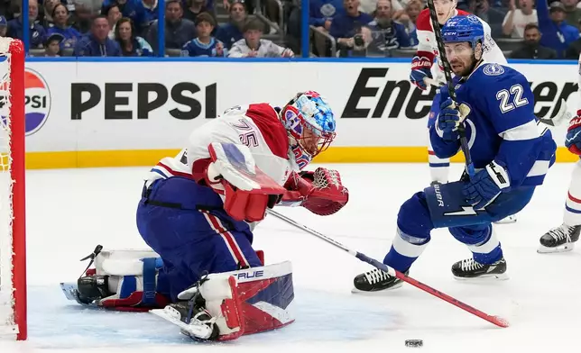 Montréal Canadiens goaltender Jakub Dobes (75) stops a shot by Tampa Bay Lightning right wing Oliver Bjorkstrand (22) during the second period in Game 5 of an NHL hockey Stanley Cup first-round playoff series, Wednesday, April 29, 2026, in Tampa, Fla. (AP Photo/Chris O'Meara)