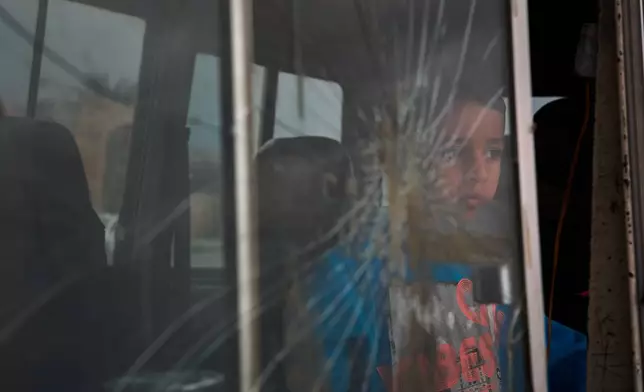 A boy who fled with his family following Israeli strikes in southern Lebanon sits inside the van they are using as shelter in Sidon, Lebanon, Thursday, April 2, 2026. (AP Photo/Emilio Morenatti)