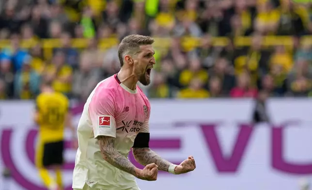 Leverkusen's Robert Andrich celebrates after scoring during the German Bundesliga soccer match between Borussia Dortmund and Bayer Leverkusen in Dortmund, Germany, Saturday, April 11, 2026. (AP Photo/Martin Meissner)