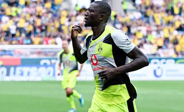 Dortmund's Serhou Guirassy celebrates after scoring during their German Bundesliga soccer match against TSG 1899 Hoffenheim in Sinsheim, Germany, Saturday, April 18, 2026. (Uwe Anspach/dpa via AP)