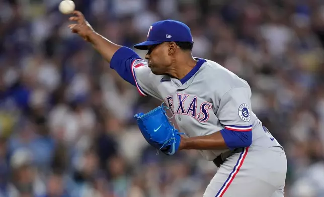 Texas Rangers pitcher Kumar Rocker throws to the plate during the first inning of a baseball game against the Los Angeles Dodgers, Friday, April 10, 2026, in Los Angeles. (AP Photo/Mark J. Terrill)