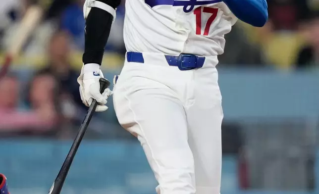 Los Angeles Dodgers' Shohei Ohtani raises his Hans after hitting a foul ball during the first inning of a baseball game against the Texas Rangers, Friday, April 10, 2026, in Los Angeles. (AP Photo/Mark J. Terrill)