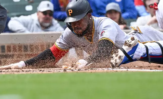 Pittsburgh Pirates' Oneil Cruz (15) scores against the Chicago Cubs during the third inning of a baseball game, Saturday, April 11, 2026, in Chicago. (AP Photo/Matt Marton)
